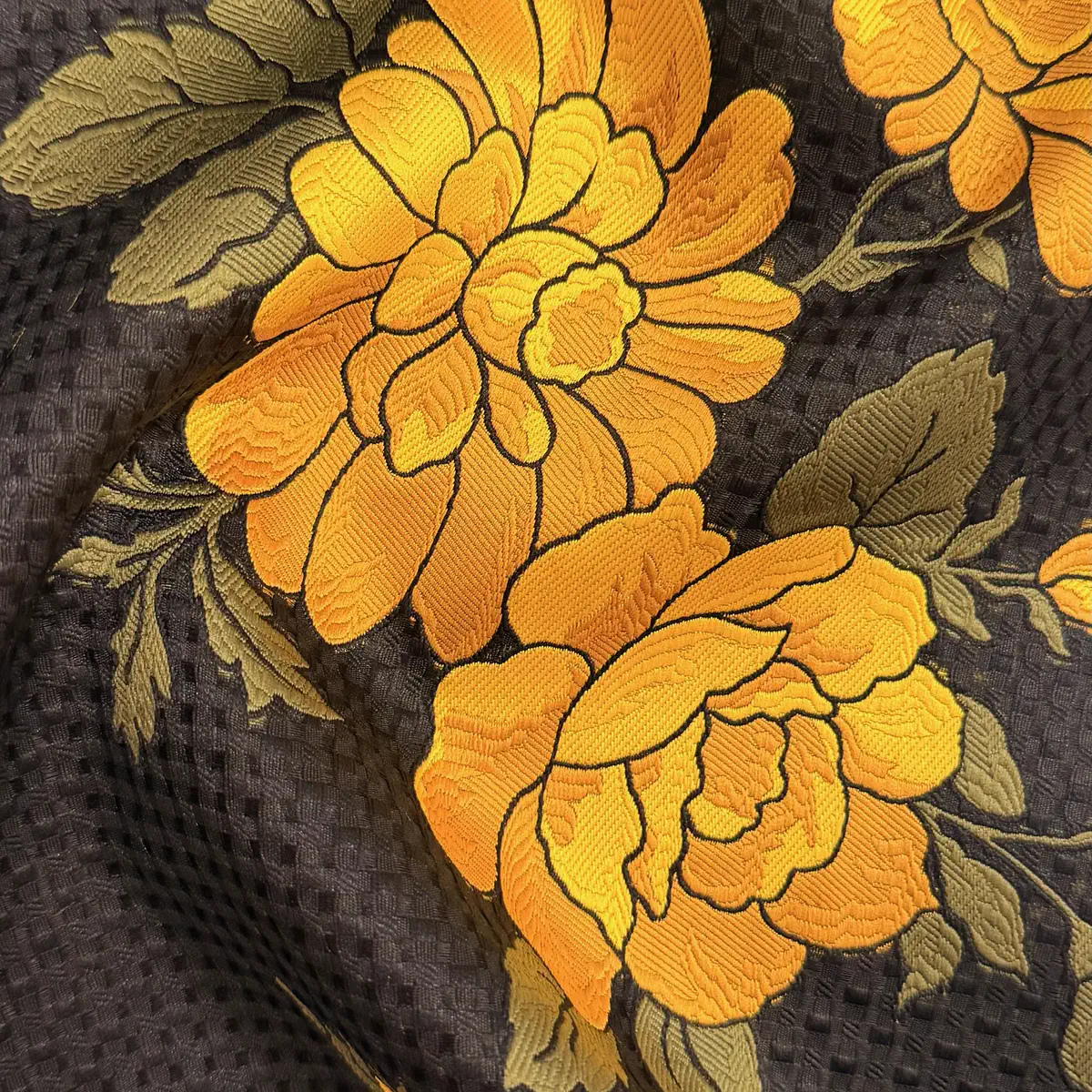 Yellow chrysanthemums embroidered on black waffle cloth