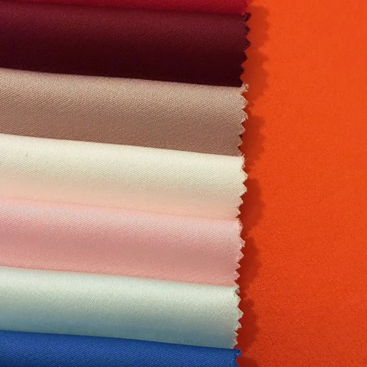 Crepes stacked in red, taupe, blush, mint, and blue