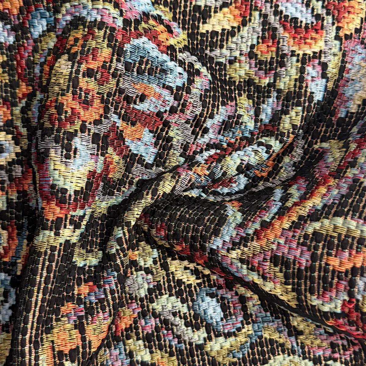 Multicoloured tapestry jacquard on a dark ground, gathered into a fold