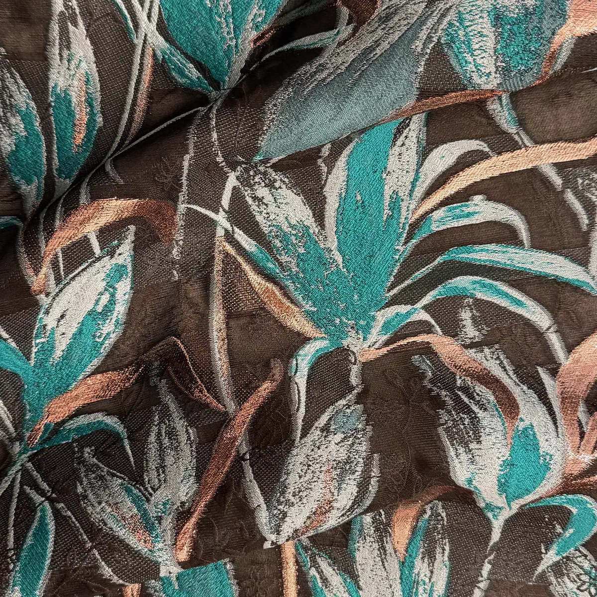Teal and coral tropical leaves on a brown ground